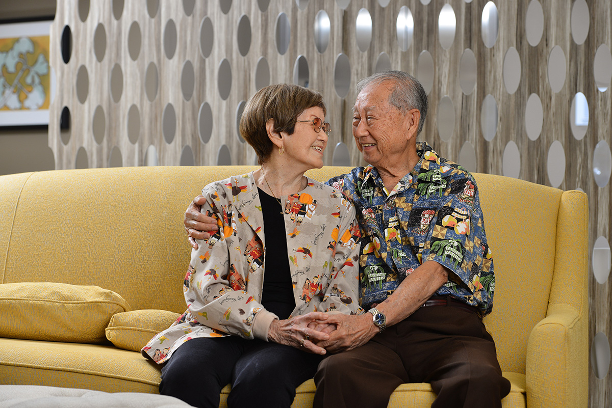 Elderly woman and man sitting on a couch